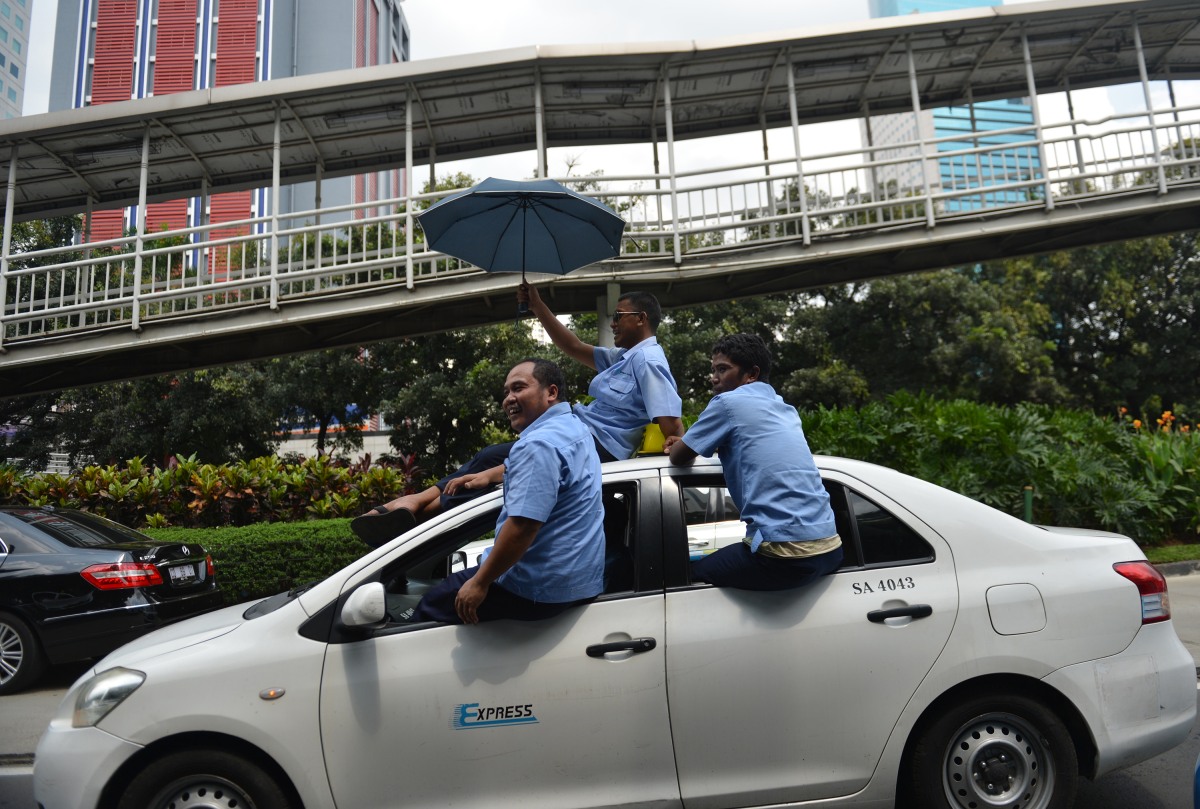 Supir taksi melakukan aksi demo menolak keberadaan angkutan umum online di Jalan Jenderal Sudirman, Jakarta, Selasa (22/3). Ribuan sopir taksi, bajaj dan sejumlah angkutan umum lainnya melakukan mogok massal untuk menolak keberadaan transportasi umum berbasis aplikasi. ANTARA FOTO/Prasetyo Utomo/nz/16