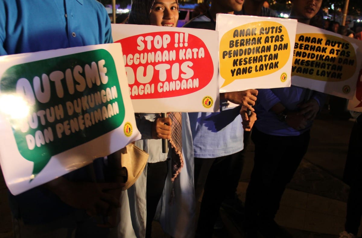 sejumlah simpatisan memegang poster saat memperingati hari peduli autis sedunia di anjungan pantai losari, makassar, sulawesi selatan, sabtu (2/4) malam. dalam aksi tersebut mereka mengajak masyarakat agar lebih peduli dan memberikan perhatian terhadap penyandang autis. antara foto/abriawan abhe/ama/16 HARI PEDULI AUTIS SEDUNIA