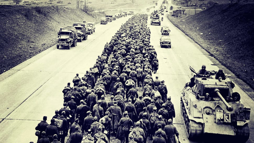 Ribuan tahanan perang Jerman berjalan dikawal oleh pasukan Sekutu mengendarai tank, truk, dan jip (4/5/1945). FOTO/CORBIS Demiliterasi Tentara Nazi Jerman