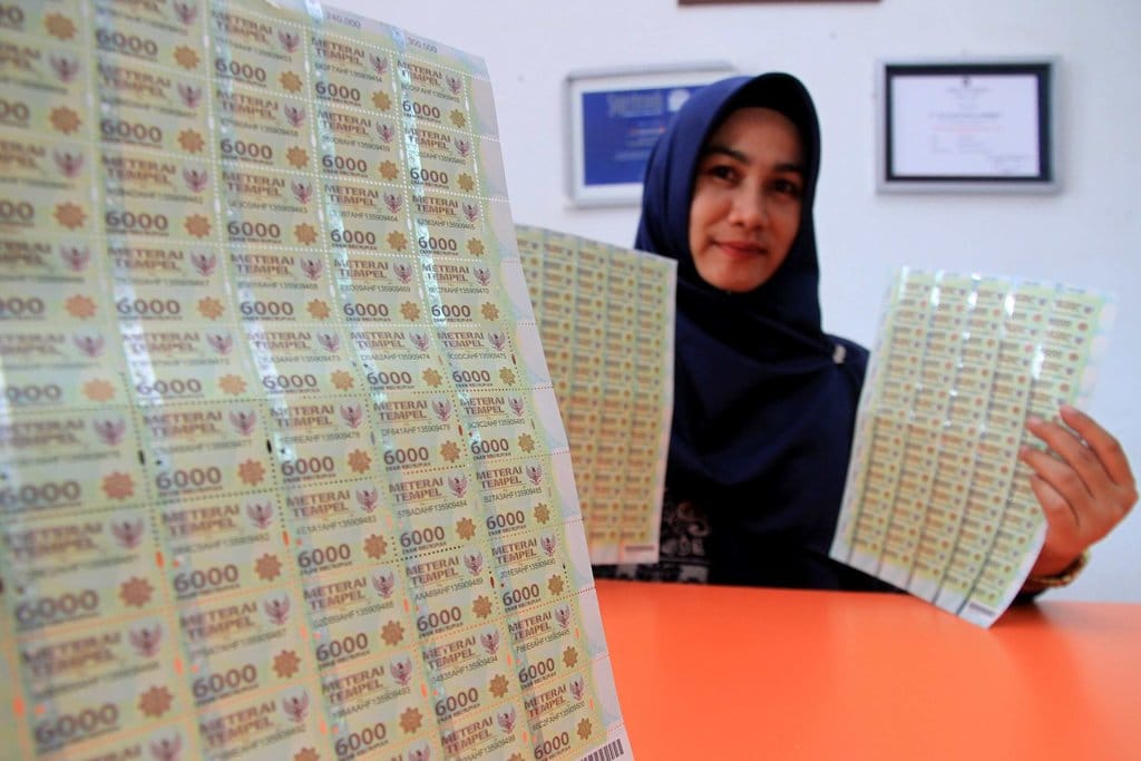 Petugas memperlihatkan materai 6.000 di Kantor Pos Meulaboh, Aceh Barat, Aceh, Jumat (22/11/2019). ANTARA FOTO/syifa yulinnas/aww. PENJUALAN MATERAI MENINGKAT