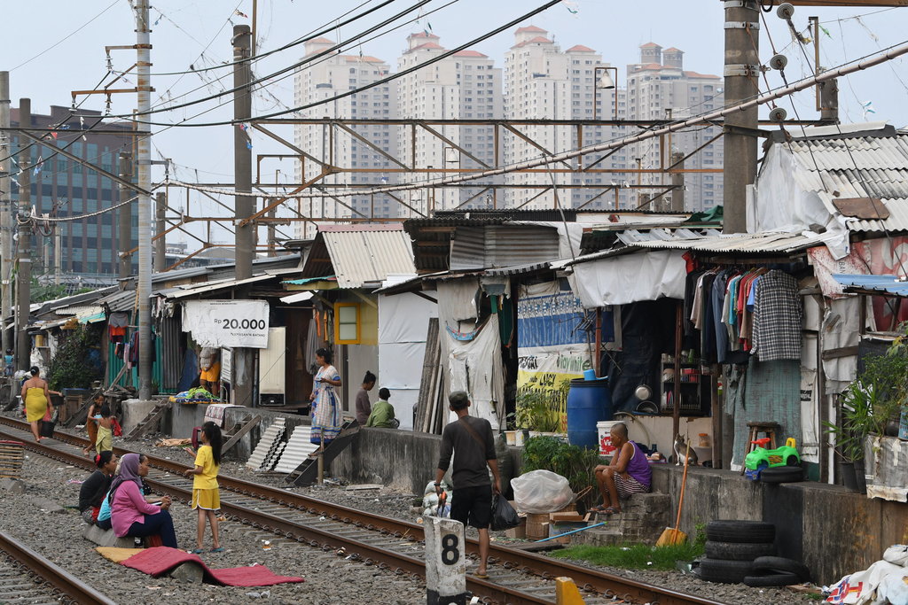 Sejumlah warga beraktivitas di perkampungan padat penduduk tepi rel kereta api di Kampung Bandan, Jakarta, Jumat (14/10/2022). ANTARA FOTO/Aditya Pradana Putra/tom. ANGKA KEMISKINAN DI JAKARTA