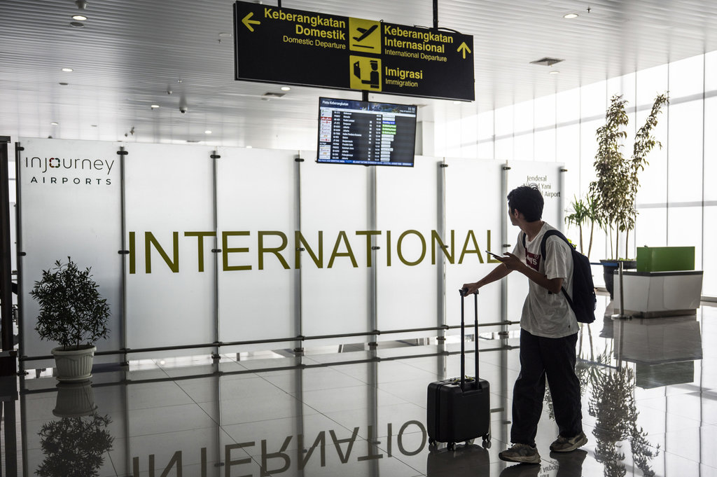 Seorang calon penumpang melihat jadwal keberangkatan pesawat di ruang tunggu keberangkatan internasional Bandara Jenderal Ahmad Yani, Semarang, Jawa Tengah, Jumat (5/9/2025). Bandara Internasional Jenderal Ahmad Yani Semarang resmi membuka kembali penerbangan rute internasional Semarang - Kuala Lumpur melalui maskapai AirAsia yang beroperasi dengan frekuensi penerbangan tujuh kali dalam seminggu menggunakan pesawat jenis Airbus A320. ANTARA FOTO/Aprillio Akbar/YU Penerbangan internasional perdana Bandara Ahmad Yani