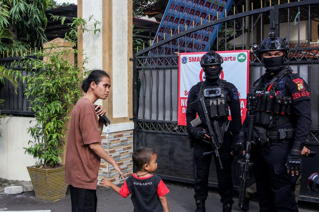 Wali murid menanyakan kabar anaknya kepada Personil Gegana Brimob Polda Metro Jaya yang berjaga pasca terjadi ledakan di depan gerbang SMAN 72 Jakarta, Jumat (7/11/2025). ANTARA FOTO/Naufal Khoirulloh/foc. Penjagaan pasca ledakan di SMA 72 Jakarta