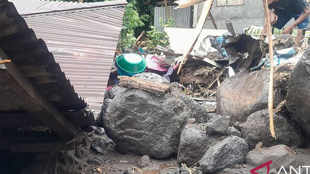Warga melihat kondisi rumah yang tertimbun material lumpur dan bebatuan setelah terjadi banjir bandang di sejumlah kampung/desa di Pulau Siau pada Senin (5/1) dini hari. ANTARA/Stenly Gaghunting Banjir Bandang Lumpur Pulau Siau