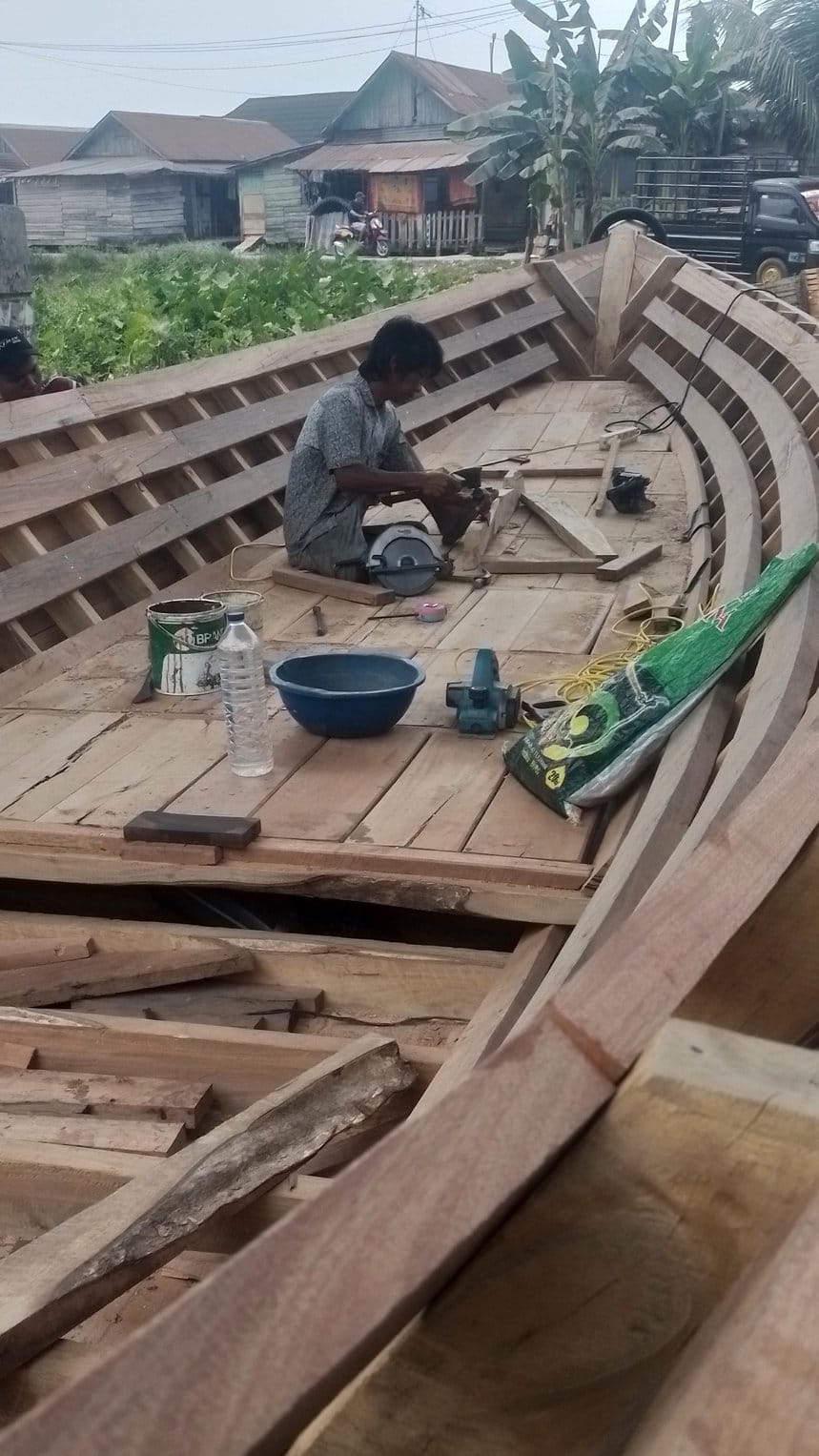 Perajin tengah menyelesaikan pembuatan perahu getek khas Palembang, Kamis (17/9/2026). FOTO/Irwanto Perahu Getek Palembang