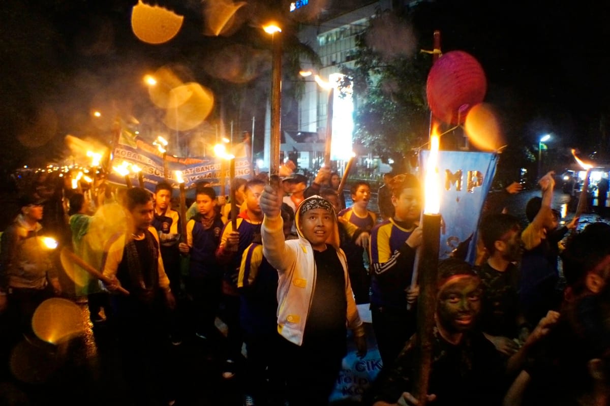 Sejumlah pelajar mengikuti pawai obor Peringatan Bandung Lautan Api di Bandung, Jawa Barat, Rabu (23/3). Bandung Lautan Api yang terjadi pada 24 Maret 1946 merupakan peristiwa perjuangan rakyat Bandung melawan penjajah dengan membumihanguskan seluruh bangunan di Kota Bandung. ANTARA FOTO/Agus Bebeng