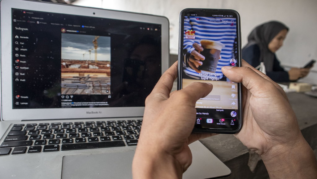 Warga menggunakan aplikasi media sosial Instagram dan TikTok di Kota Cimahi, Jawa Barat, Jumat (31/1/2025). ANTARA FOTO/Abdan Syakura/foc. Rencana penerapan Sistem Kepatuhan Moderasi Konten