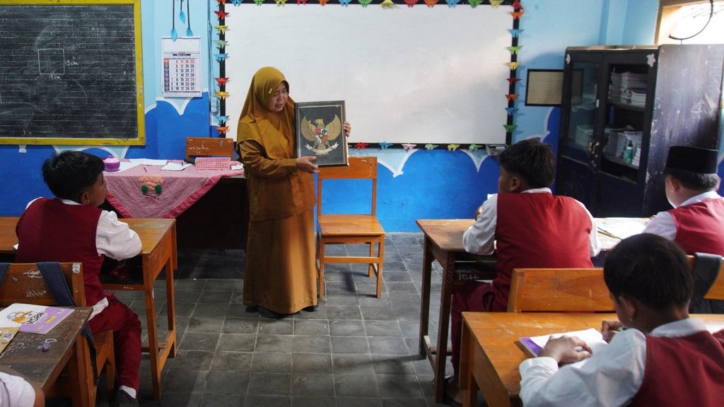 Seorang guru menyampaikan materi saat kegiatan belajar mengajar di SD Negeri Kudus 2, Lumajang, Jawa Timur, Senin (19/5/2025). ANTARA FOTO/Irfan Sumanjaya/rwa. Kemendikdasmen siap salurkan bantuan guru honorer