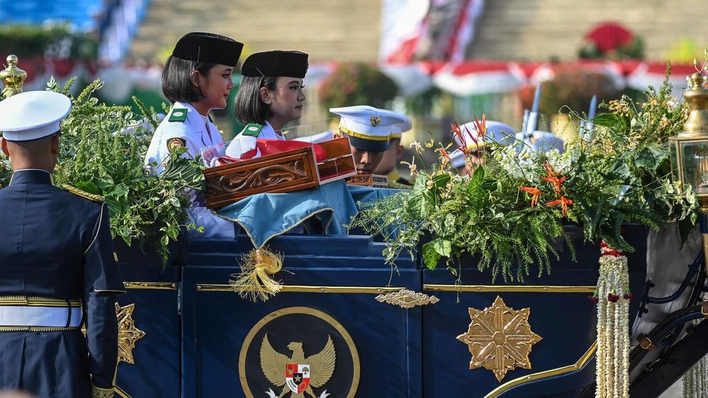 Purna Paskibraka Duta Pancasila 2024, Kirana Ashawidya Baskara (kedua kiri) dan Ni Komang Tri Setia (ketiga kiri) membawa baki duplikat Bendera Pusaka Merah Putih dan Teks Proklamasi saat menaiki Kereta Kencana Garuda Prabayeksa pada Kirab Merah Putih HUT ke-80 Republik Indonesia di Monas, Jakarta, Minggu (17/8/2025). ANTARA FOTO/Sulthony Hasanuddin/wpa. Kirab Merah Putih HUT ke-80 RI