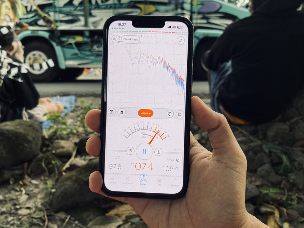 Pengukuran tingkat kekerasan suara dengan aplikasi Decibel X ketika truk sound horeg melintas. (Tirto.id/Fadrik Aziz Firdausi) Karnaval Sound Horeg di Kediri