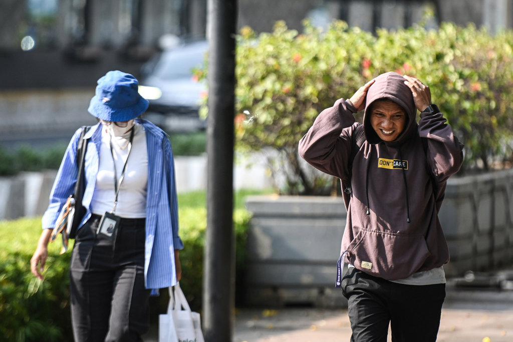 Warga mengenakan penutup kepala saat cuaca terik di kawasan Bundaran HI, Jakarta, Rabu (15/10/2025). Badan Meteorologi, Klimatologi, dan Geofisika (BMKG) mengungkap fenomena cuaca panas yang melanda sebagian besar wilayah Indonesia disebabkan posisi gerak semu matahari yang pada Oktober berada di selatan ekuator dengan suhu maksimal 36,7 derajat celsius, dan diprakirakan akan terjadi hingga November 2025. ANTARA FOTO/Sulthony Hasanuddin/rwa. Fenomena cuaca panas diprakirakan hingga November 2025